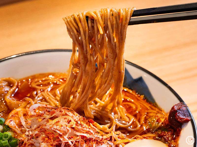 A tangy sensation hits as you slurp these noodles