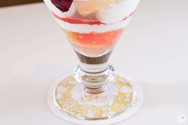 Cut fruit and strawberry jelly at the bottom of the parfait