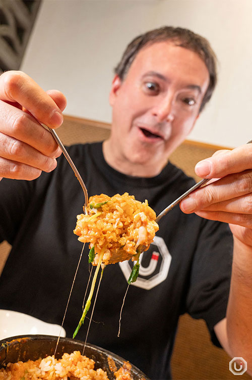 Photo of Bensky stirring the Ishiyaki Taco Rice