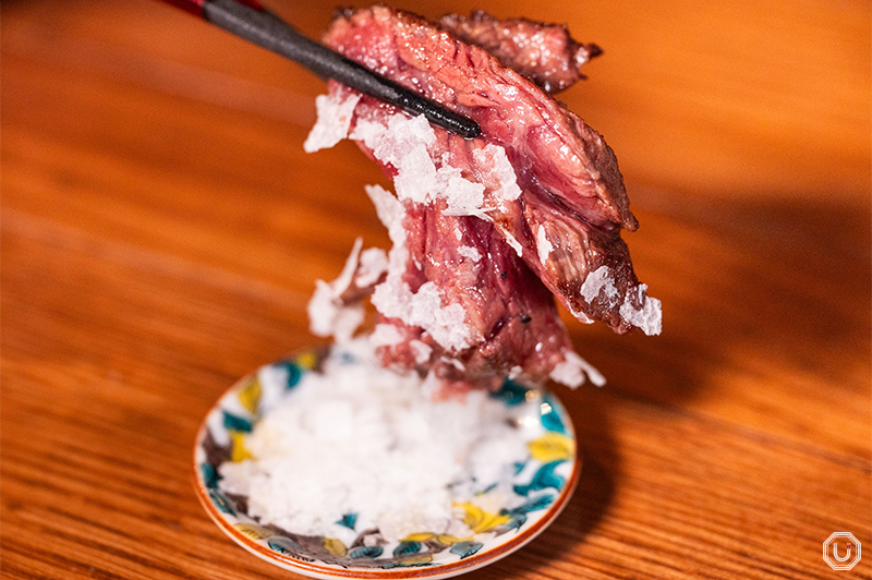 Photo of Specialty Wet-aged Outside Skirt Steak being seasoned with snow salt
