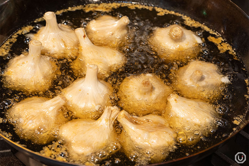 Photo of garlic bulbs being fried