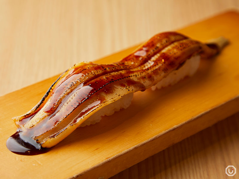 Conveyor-belt sushi restaurant Magurobito Akihabara offers conger eel sushi