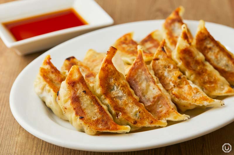 Vegetable Gyoza arranged on a plate with crispy golden edges