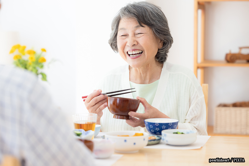 senior Japanese lady eating with chopsticks