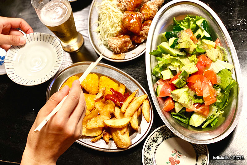 holding chopsticks indecisively over dishes in a breach of Japanese chopsticks etiquette