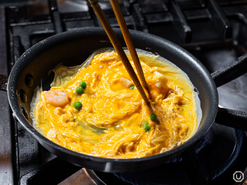Preparing the eggs for omelet rice