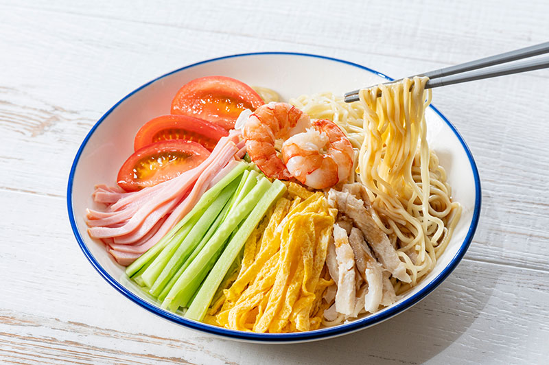 Hiyashi Chuka (cold ramen dish) in a bowl with colorful toppings