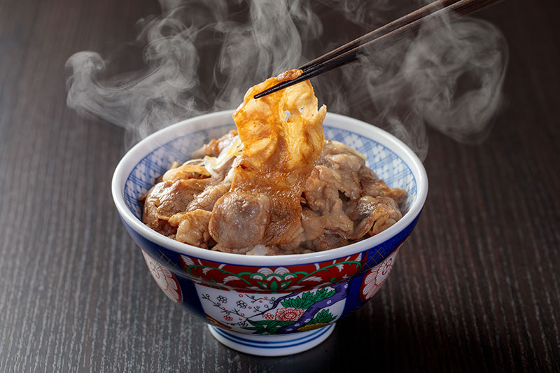 Using chopsticks to eat donburi