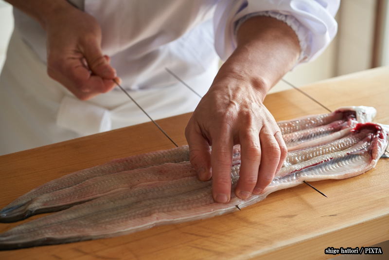 a Japanese chef preparing unagi