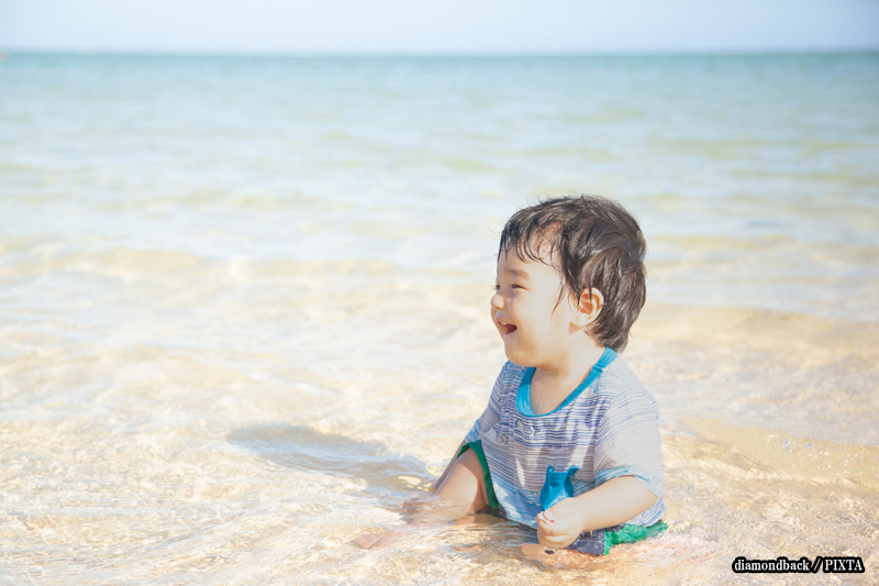 a young child playing at the beach in Japan
