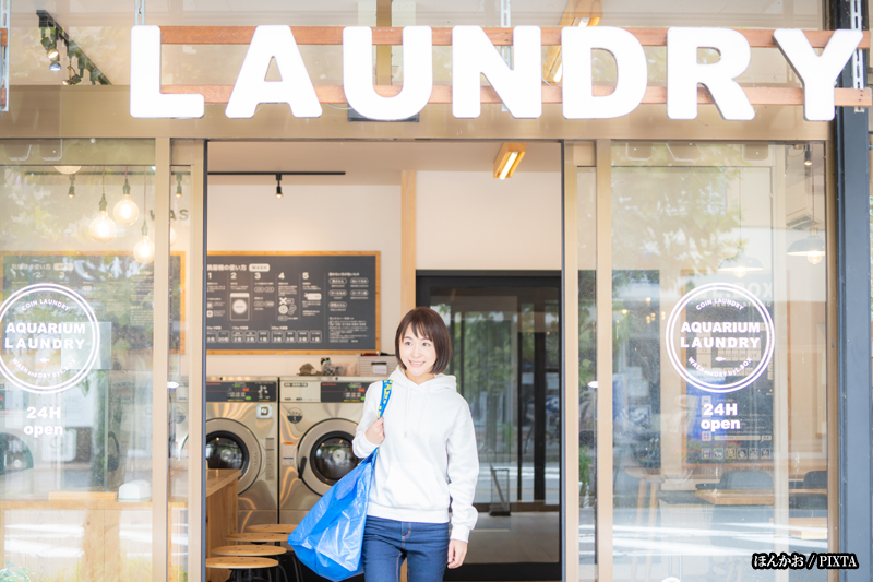 a Japanese woman exiting a laundromat
