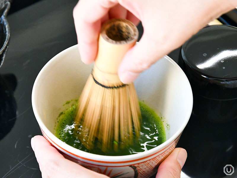 Whisking matcha with a chasen at AN TOKYO Japanese Culture Experience