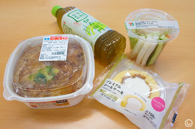Vegetable sticks, katsudon, dessert, and drink from a convenience store